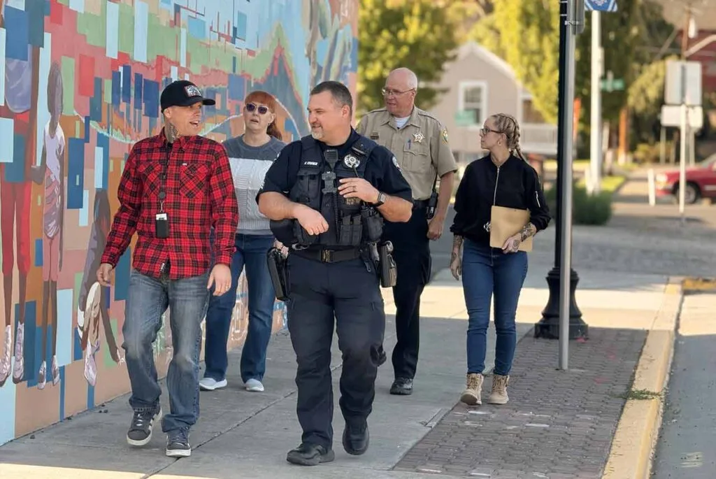 multi-disciplinary team of case managers, local shelter president, law enforcement, and LEAD project manager collaborating in downtown Dalles